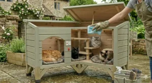 A stylish grey-painted outdoor cat house that matches modern British garden decking and furniture.