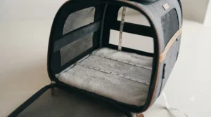 Detailed texture view of the durable, water-resistant material and tan leather-look trim on a cat carrier.
