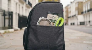 External side pockets on the rolling cat carrier holding a travel bowl and lead.
