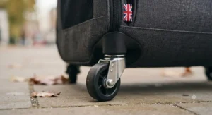 Close-up of the sturdy rubber wheels on the base of a rolling cat carrier.